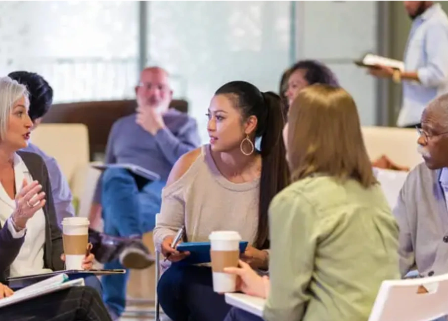 Adults engaged in a group discussion about relapse prevention