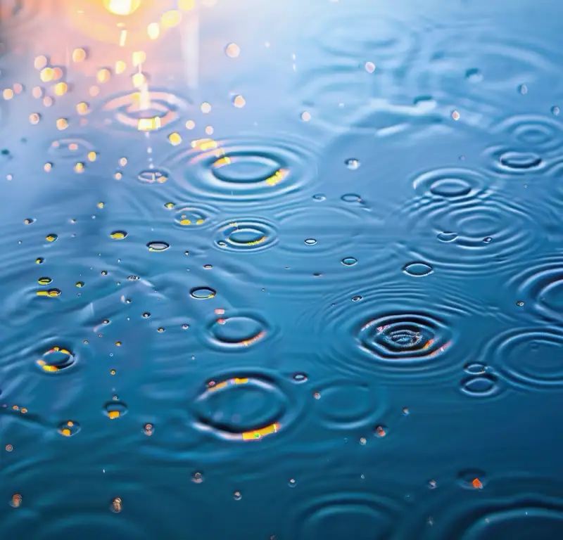 Close-up of water ripples with soft reflections, symbolizing the ripple effect of recovery and the benefits of giving up alcohol through the 12 steps of AA.