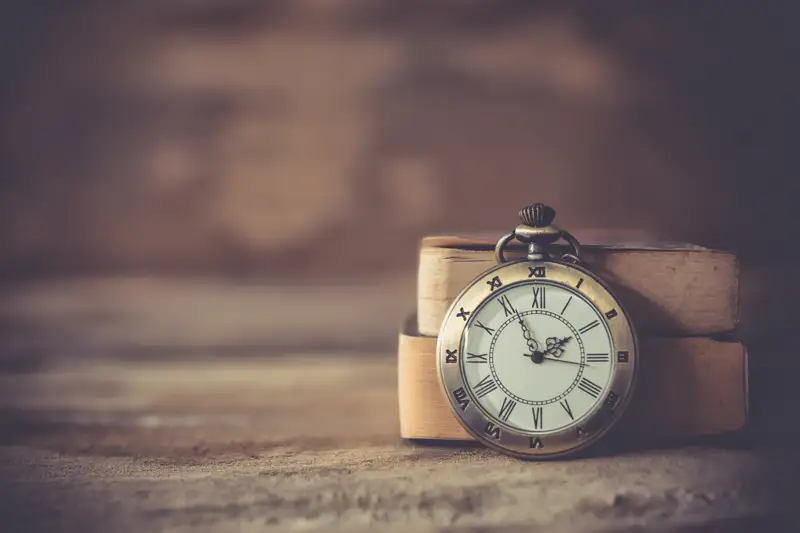 A vintage pocket watch placed on a wooden surface, symbolizing the passage of time and the patience required during benzo withdrawal and addiction recovery.