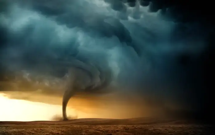 A tornado sweeping across a barren landscape at sunset, symbolizing the intense and destructive nature of benzo addiction and the process of withdrawal.