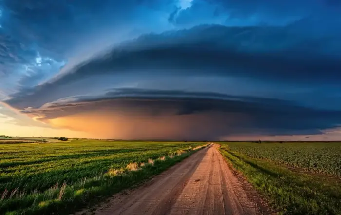 A storm cloud over a dirt road at sunset, symbolizing the challenging process of experiencing Adderall withdrawal effects.